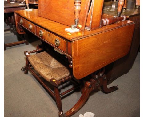 A George IV mahogany and banded sofa table, fitted two drawers, on brass line inlaid lyre end supports and splay feet, 37" wi