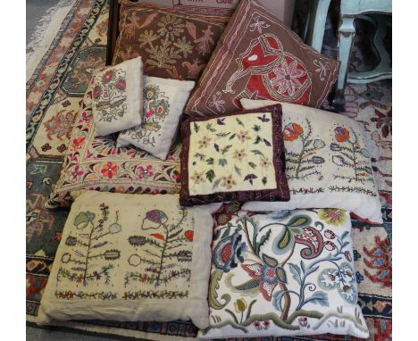 Seven embroidered cushions, various, and a crewel work cushion 