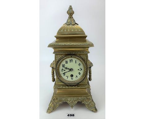 Antique French brass mantle clock with lion handles and enamel face. Working with key and pendulum