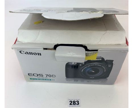 Canon EOS 450D digital camera in box with strap, accessories and instructions