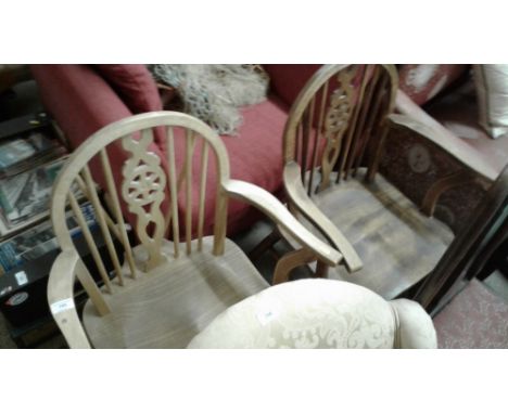 A pair of elm seated stick and wheel back elbow chairs