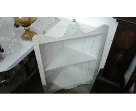 A painted corner two tier wall shelf