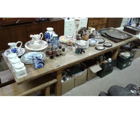 A large light oak extending dining table with a pair of matching benches