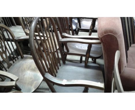 A pair of elm seated stick back elbow chairs