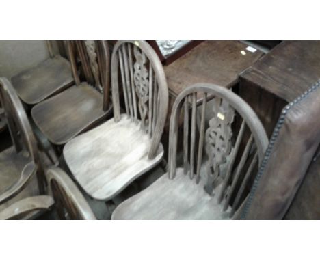 A set of four stick and wheel back kitchen chairs