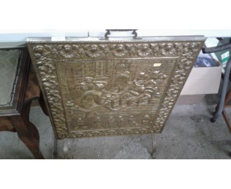 A brass embossed firescreen