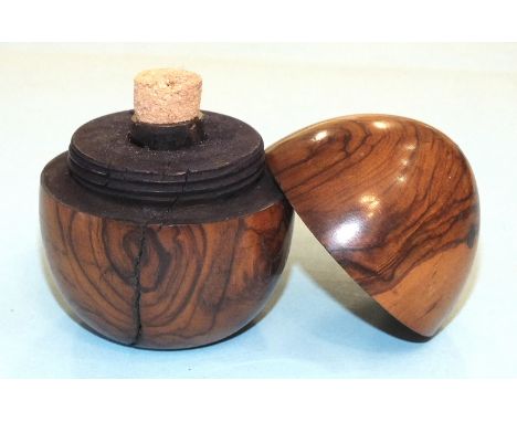 An olive wood egg-shaped travelling inkwell, the screw top over a glass bottle, 6.5cm high.