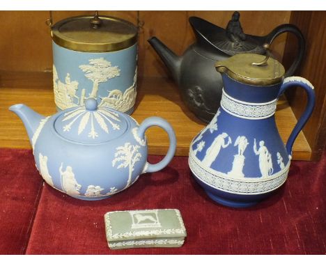 A damaged Wedgwood black basalt shaped teapot and cover decorated with putti and Bacchanals, 20cm high, a Wedgwood jasperware