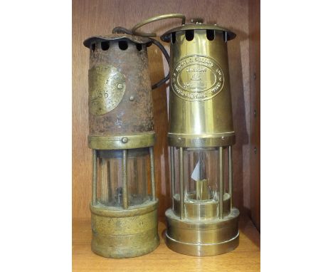 A brass and iron minor's lamp with indistinct maker's plaque, (possibly Alwood's?), 26cm and a later brass miner's lamp, (2).