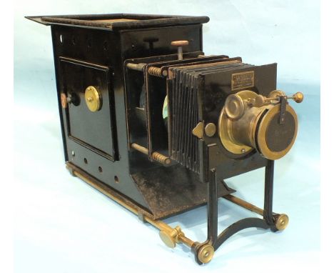 A Newton &amp; Co. magic lantern with adjustable 9'' focus lens, bellows and Japanned tin body, in metal case.