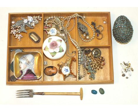 An egg-shaped metal box collet-set blue pastes, a fork in the form of a garden fork and other items.