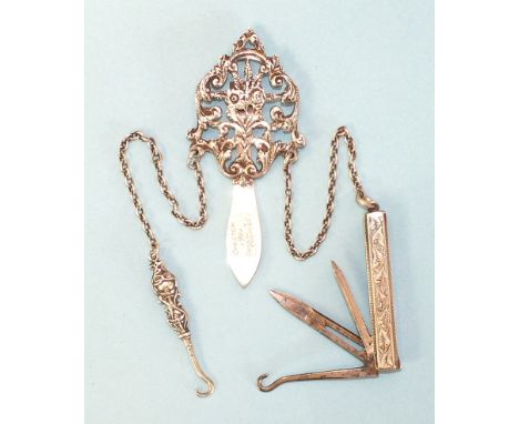 An early-20th century silver chatelaine of pierced floral form, by Colen Hewer Cheshire, Chester 1901, the two chains support