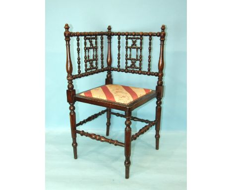 A stained wood bobbin-turned corner chair with padded seat, 76cm high.