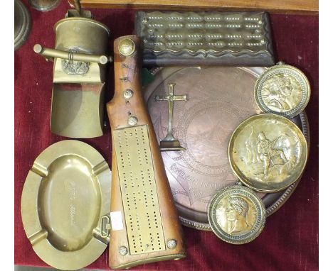 A brass cribbage board mounted in a rifle stock decorated with military buttons, a 'trench art' shell in the form of a coal s