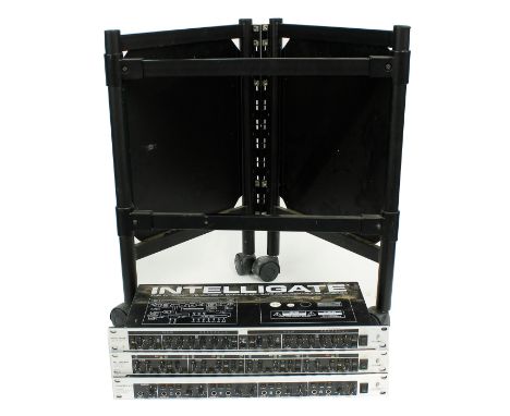 Three Behringer rack units to include an Intelligate, an Autoquad and a Powerplay; together with a small rack stand on wheels