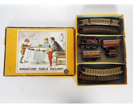 Bing - A boxed OO gauge Bing Miniature Table Railway Set 2. The set contains a clockwork 2-4-0 steam locomotive OP.No.513 in 