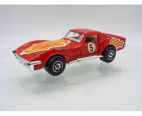 Dinky Toys - A curious variant of Dinky Toys #206 Customised Corvette Stingray. The unboxed model  in red with flame decals t