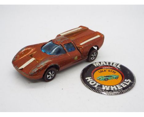 Hot Wheels - Redlines - A 1968 dated Hong Kong made Lola GT70 in hard to find orange with its original Collector's Button. Th