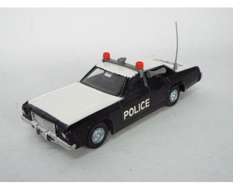 Dinky Toys - An unusual and unlisted version of Dinky Toys #244 Plymouth Fury Police Car. The unboxed model in black and whit