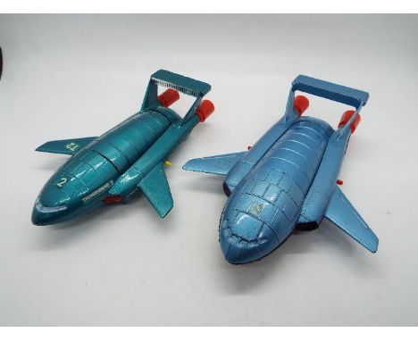 Dinky Toys - Two unboxed examples of Dinky Toys Thunderbirds II. Lot includes an early #101 in metallic  green body, red thru