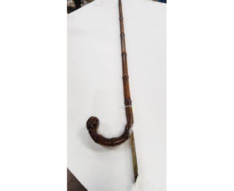 A 19th Century cane walking stick with concealed horse measure having white metal cover, 91cm.