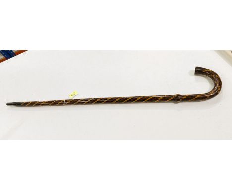 An early 20th Century walking stick with coverall spiral geometric inlaid decoration, 80cm.