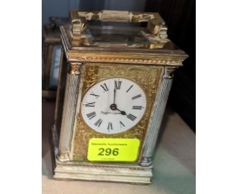 A 19th century style brass carriage clock by Mappin &amp; webb, with reeded corner pillars, ornately pierced dial surround an