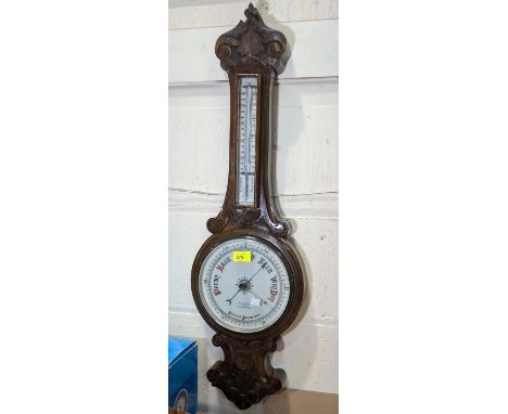 An early 20th Century carved oak banjo shaped aneroid barometer with thermometer, by Ben Franks, Hull.