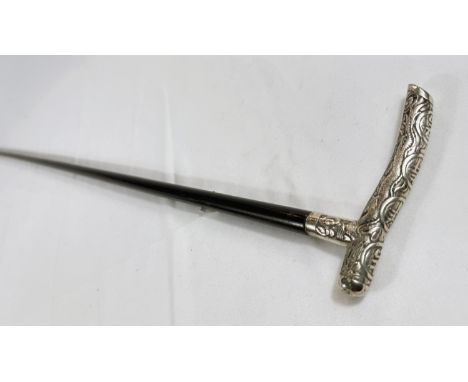 A Chinese lady's ebonised walking stick with silver handle embossed with characters, 90cm.Good overall condition.WE TAKE GREA