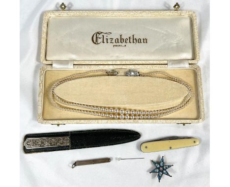 A hallmarked silver retractable tooth pick with engine turned decoration; a star brooch; a white metal letter opener; a penkn