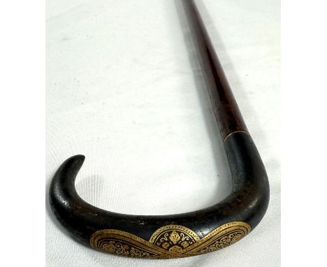An Edwardian slender hardwood stick with gilt inlaid steel handle, possibly Russian, 90cm.
