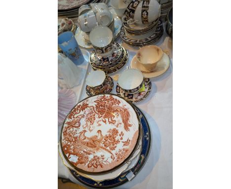 A Royal Crown Derby cup and saucer, other Royal Crown Derby saucers, a similar Imari pattern set and a Victorian blue and gil