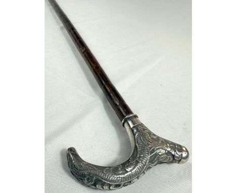 A Chinese lady's walking cane with silver handle decorated with a dragon, 85cm.Good overall condition.WE TAKE GREAT CARE in t