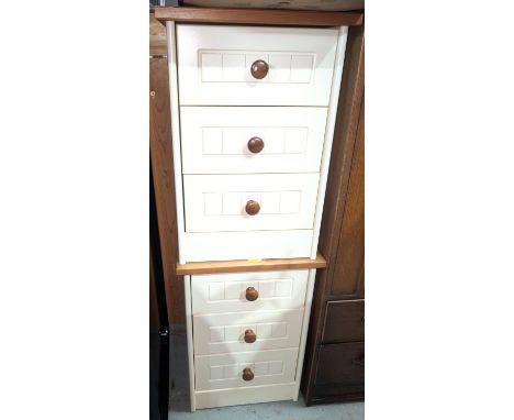 A pair of modern pine and white finish three-height bedside cabinets and a John Lewis lamp.