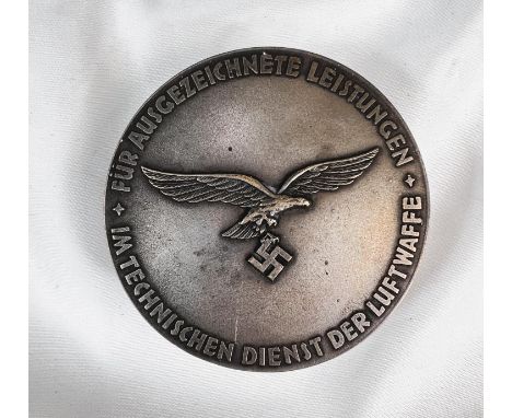 A German WWII style snuff box with relief details to each side.
