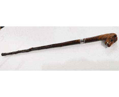 A vintage rustic walking stick with carved head finial of a snaggle-toothed monster, 90cm.