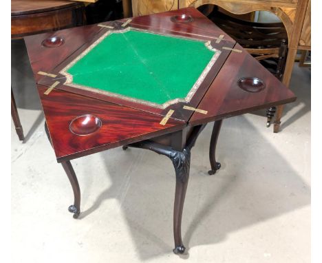 A late 19th Century/early 20th Century mahogany envelope card table on carved cabriole legs and castors.