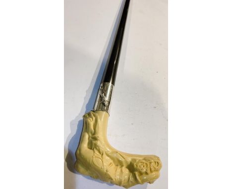 An Art Nouveau lady's walking stick with ebonised shaft and moulded ivorine handle in the form of a reclining woman, 89cm.