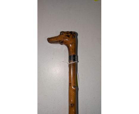 A 19th Century hunting stick with silver collar engraved and dated 1868 with carved fox hound finial, 83cm.