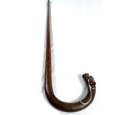 A 19th Century walking stick, the looped handle with finial in the form of a dog's head, silver mounted, 86cm.
