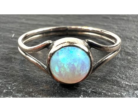 An unmarked dress ring set with an opal, 1 gm, size K (tests as circa 9ct)