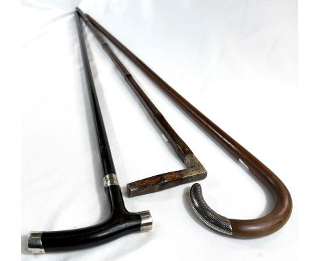 A vintage square-section stick with white metal mount, another with niello work finial and an ebony stick, 90-95cms (3).