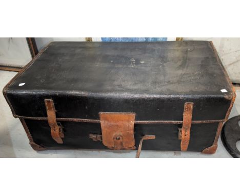 A 19th century Railway trunk with wooden slats on the base black in colour with tan leather bindings