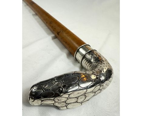 A 19th Century heavy Malacca cane walking stick with silver handle in the form of a snake's head (unmarked), 92cm.