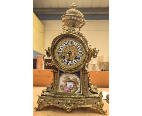 A reproduction Louis XV striking mantle clock with Sevres style porcelain mounts (no glass)