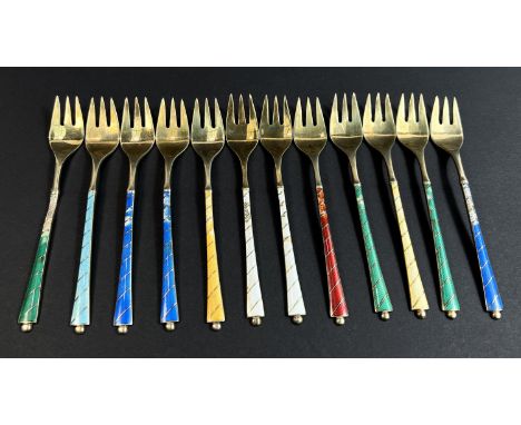 Twelve Ela Denmark gilt enamelled forks, stamped 'Sterling', 6.2 oz, some with damaged enamel.