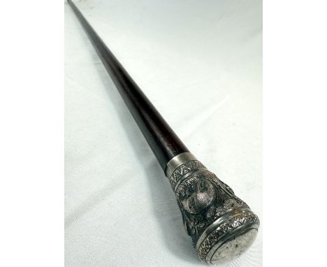 A 19th Century hardwood stick with embossed Indian silver knop decorated with wild animals, 92cm.