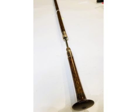 An antique Indian stick with white metal mount and circular flattened handle, 93cm, blade 29cm.