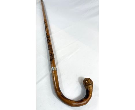 A late 19th/early 20th Century Japanese walking stick with finely carved decoration of three monkeys climbing a vine, signed,