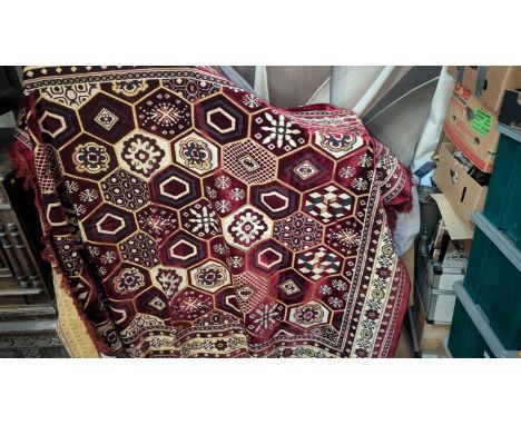 A 20th Century Turkish made maroon ground carpet.